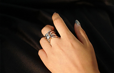 Sculptural openwork metal ring worn on a hand